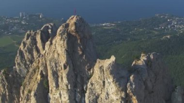 Şaşırtıcı havadan görünümü. Uçuş AI-Petri dağın kaya tepe üzerinde. Çok yavaş hareket. Kırım Yalta şehir. Yaz günü saat.