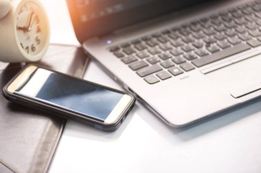 Dizüstü bilgisayar, akıllı telefon çalar saat erken sabah ofiste ile Danışma