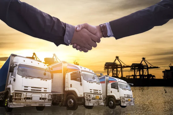 Logistics and Transportation Truck and Cargo ship with Business Collaboration, Businessman shake hands, logistic import export and transport industry background
