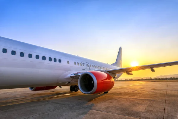 perspective view of airplane in the sunrise time at airport, travel concept