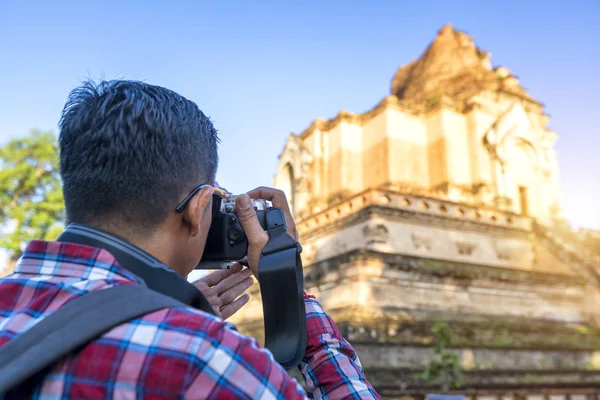 Asia travel, Traveler shooting a old temple photo at Chiang Mai, Thailand.