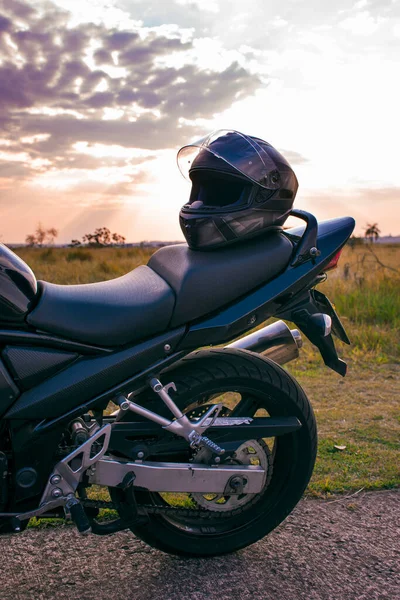 Czarny Kask Motocyklowy Umieszczony Siedzeniu Czarnego Motocykla Zaparkowanego Ulicy Naturalnym — Zdjęcie stockowe