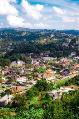 Vadide, mavi gökyüzü ve bulutları olan kırsal bir köyün bulunduğu birkaç dağ manzarası..