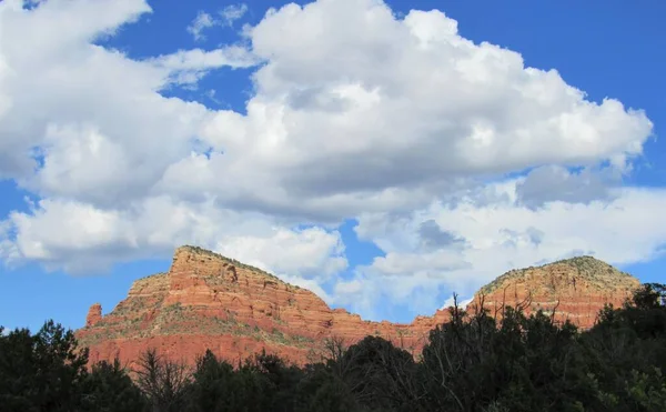 View of red rock cliffs and mountains located near Sedona, Arizona around sunset