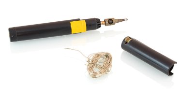 Professional gas heated soldering iron with tin solder wire isolated on white background with shadow reflection. Gas powered soldering iron with pewter solder wire and protective cap as flint igniter. clipart