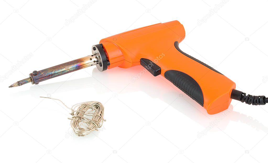 Orange pistol-shaped soldering iron (tip made of copper core plated with iron)  with tin solder wire isolated on white backgroung with shadow reflection. Soldering gun with pewter solder wire.