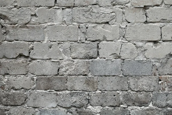 Old broken gray brick wall background. Old gray damaged brick wall texture, Gray brick backdrop and texture for text or image. Gray background for design, design and template.