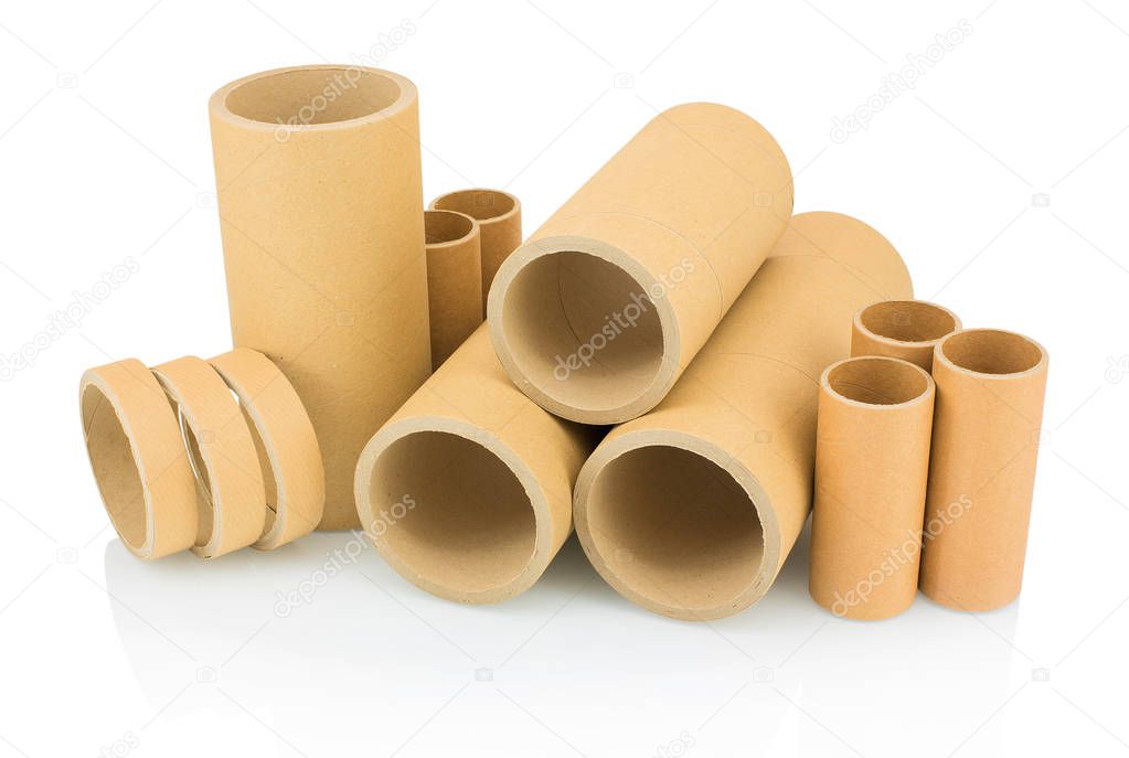 A bunch of brown industrial paper core isolated on white background with shadow reflection. A lot of paper cores or paper tubes on white backdrop. Brown paper rolls.