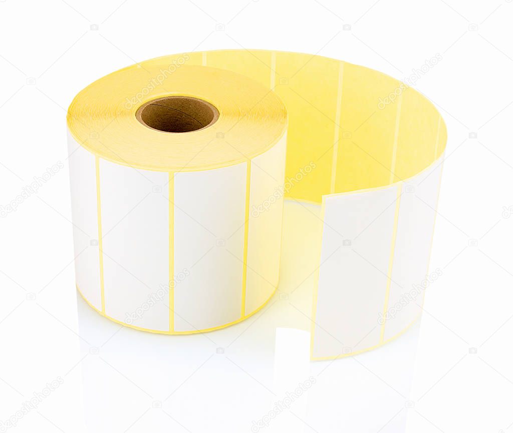 White label roll isolated on white background with shadow reflection. White reel of labels for printer. Labels for direct thermal or thermal transfer printing. Stickers on white backdrop.