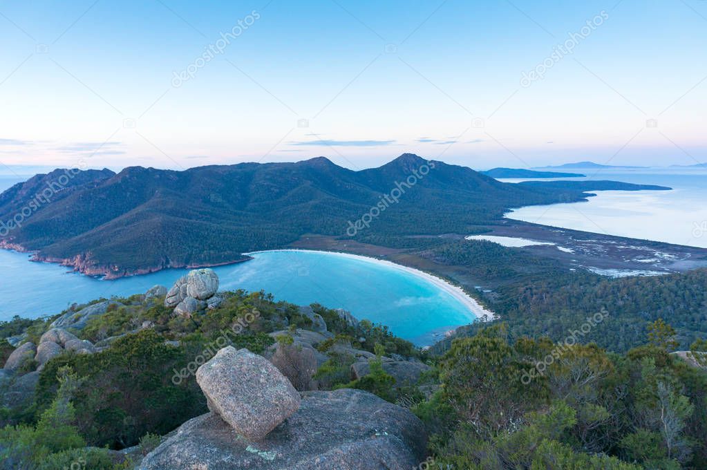 Aerial panorama of Wineglass ay beach and mountains of Freycinet National Park from Mount Amos lookout. Tasmania, Australia