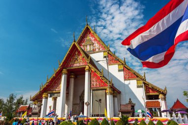Ayutthaya, Tayland - 1 Ocak 2016: Wat Mongkhon Bophit tapınağı ile Tay bayrağı ve güneşli bir günde insanlar