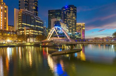 Beautiful Melbourne Southbank cityscape at night with Evan Walker pedestrian bridge across Yarra river. Victoria, Australia