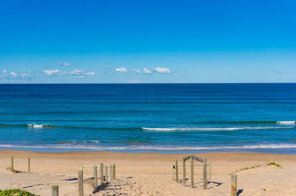 木製の手すりと穏やかな海のビーチ入り口 — ストック写真