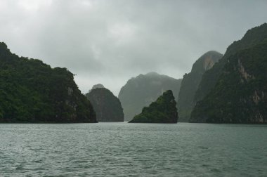 Scenic karst islands of Halong Bay on mist clipart