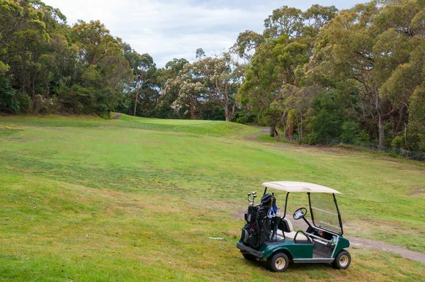 Golf car on green lawn of golf course — Stock Photo, Image