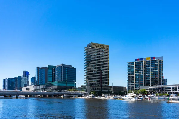 Modern buildings on the bank of river on sunny day — Stock Photo, Image