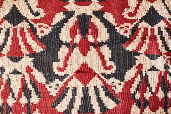The texture of the carpet. Red old carpet.