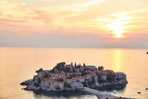 La isla de Sveti Stefan. El Resort de Montenegro. Puesta de sol en la isla de Sveti Stefan . — Foto de Stock