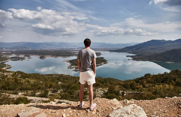 Slansky lake. The young man looks at the lake. A man admires the beauty of Montenegro. Montenegro.
