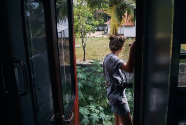 girl standing in the vestibule of the train, Sri Lanka clipart