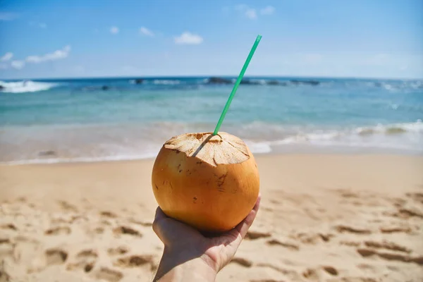 Man Holds Coconut Straw Ocean Guy Drinks Juice Coconut Ocean — Stock Photo, Image