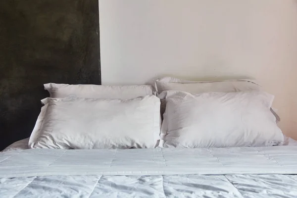 Pillows lying at the head of the bed.