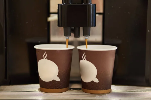 Disposable cardboard cups for coffee. Coffee machine