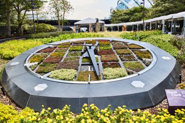 SINGAPORE - March 19, 2019: A working clock made of flower beds in the Gardens by the Bay clipart