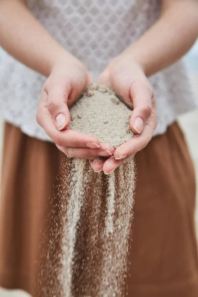 Ragazza versando sabbia dalle sue mani . — Foto Stock