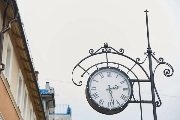 Old medieval clock on a city street. — Stock Photo, Image