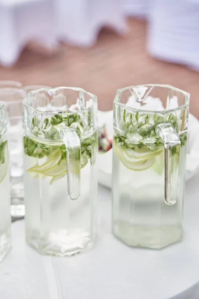 Two transparent jugs with mojito at the feast — Stock Photo, Image