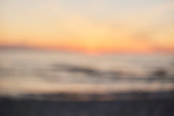 Blur sunset praia com bokeh luz onda abstrato fundo . — Fotografia de Stock