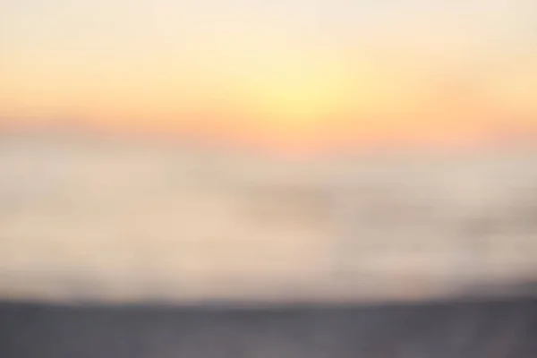 Blur sunset praia com bokeh luz onda abstrato fundo . — Fotografia de Stock