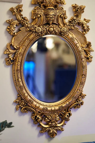 Old carved round mirror with gilding — Stock Photo, Image