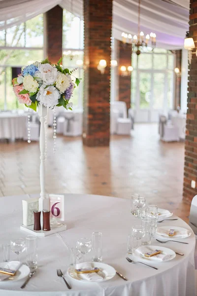 Plates with glasses on a table with a white tablecloth — Stock Photo, Image