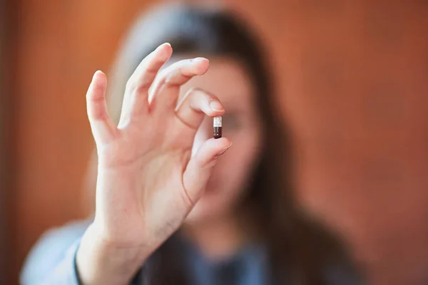 Młoda dziewczyna trzyma tabletkę w rękach. Kapsułka w dłoni. Leki. Lek — Zdjęcie stockowe