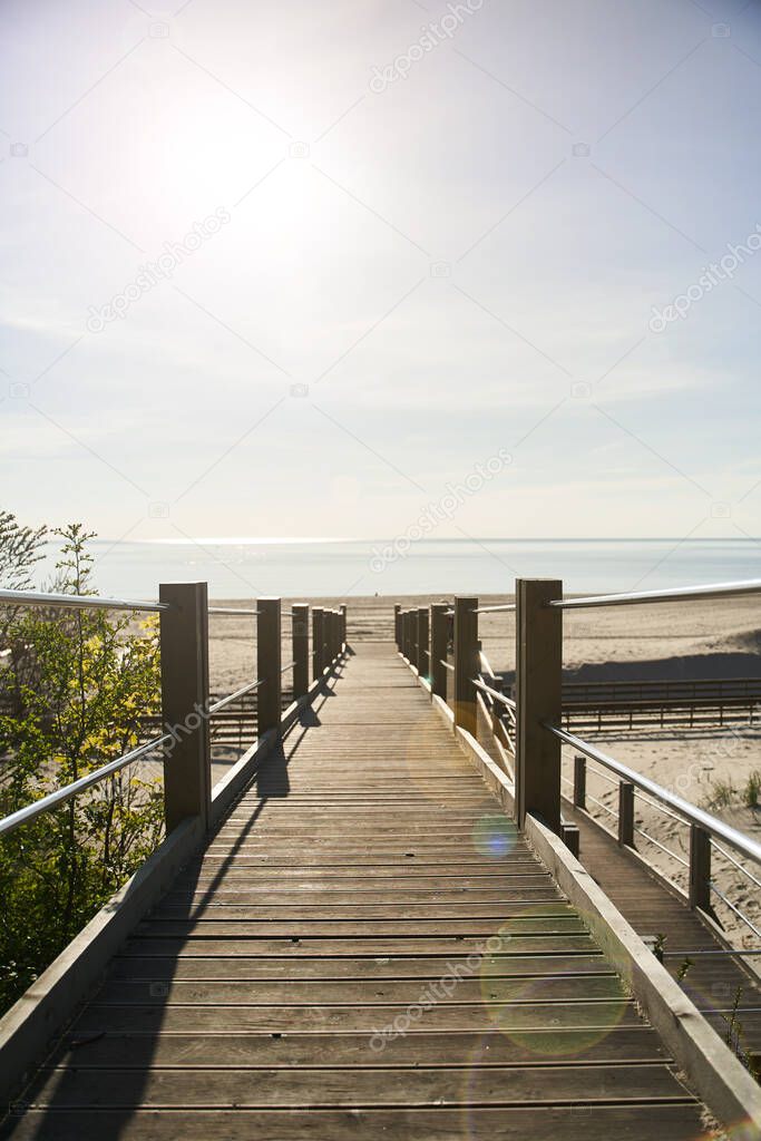 Wooden Boardwalk on Yantarniy Beach. Beach with a blue flag. Kaliningrad region