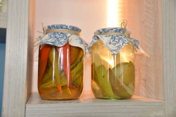 Decorative cans with pickled peppers and pears