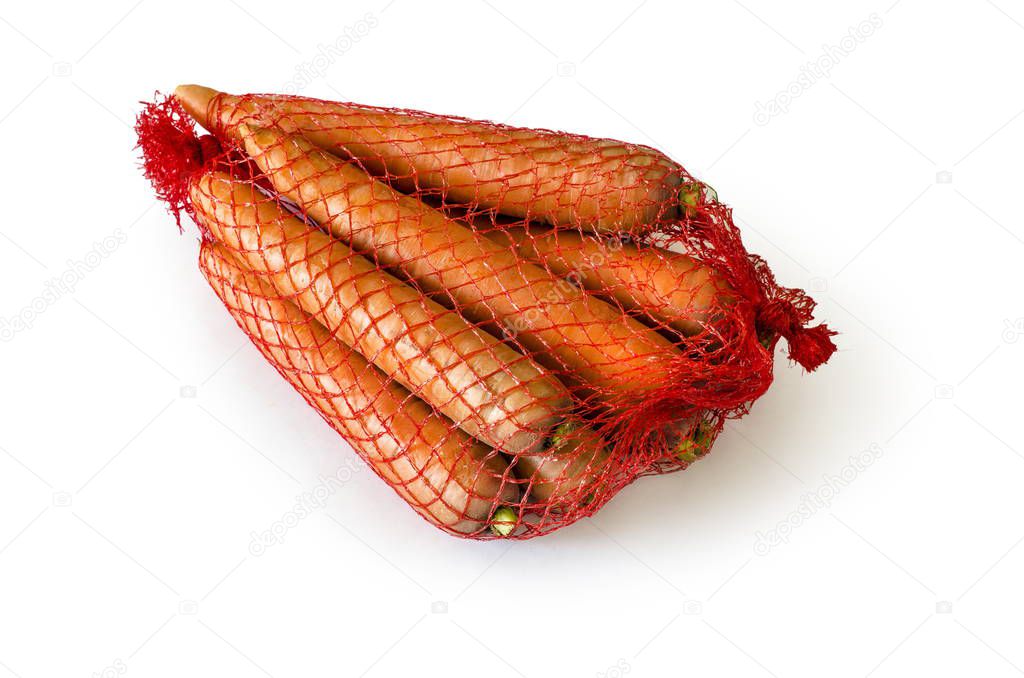 A lot of beautiful ripe orange tubed carrots in a net packed bag lie on a white isolated background.