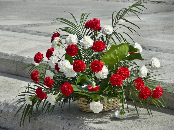 Beautiful and bright flowers. A beautiful bouquet of white and red bright flowers in a wicker basket.