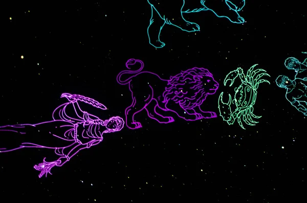 Zodiac signs art. The signs of the zodiac are colored on a black night sky in the form of an art object and installation.