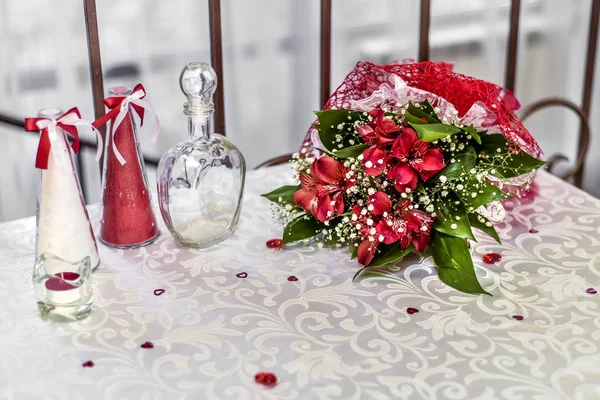 Beautiful dishes in the interior. Beautiful table setting with glasses, glasses and a plate in a white and red interior of a cafe and restaurant.