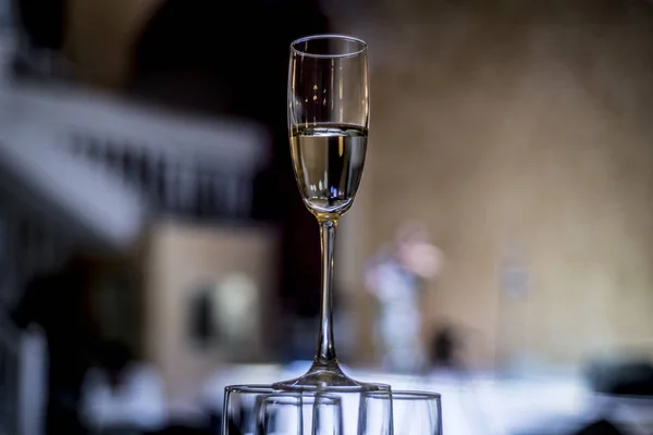 Beautiful dishes in the interior. Beautiful table setting with empty and full glasses of wine on a dark or light background in the interior of the cafe and restaurant.