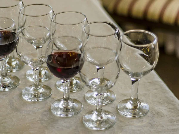 Beautiful dishes in the interior. Beautiful table setting with empty and full glasses of wine on a dark or light background in the interior of the cafe and restaurant.