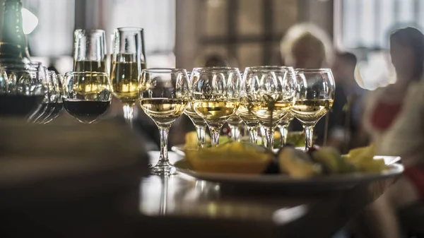 Beautiful dishes in the interior. Beautiful table setting with empty and full glasses of wine on a dark or light background in the interior of the cafe and restaurant.