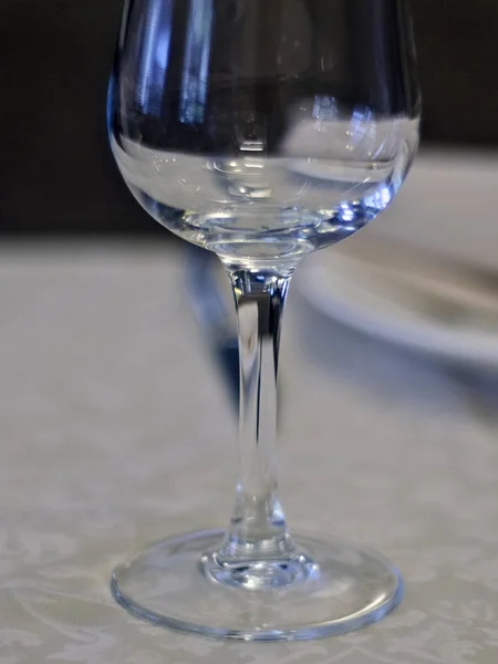 Beautiful dishes in the interior. Beautiful table setting with glasses, plates and napkins on a light background and in the interior of the cafe, bar and restaurant.