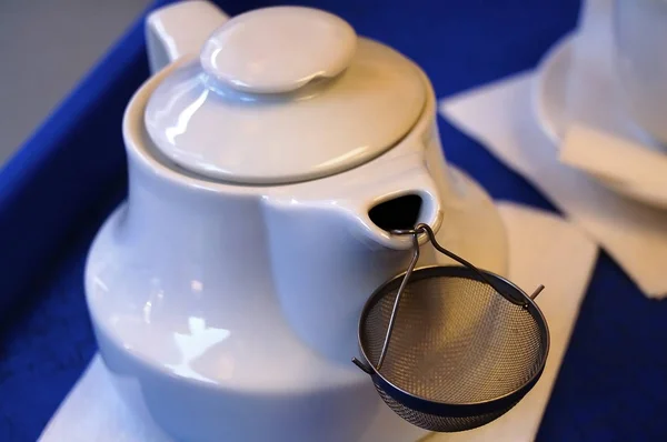 Beautiful dishes in the interior. Beautiful table setting with a kettle and tea pot in the interior of a cafe, bar and restaurant.