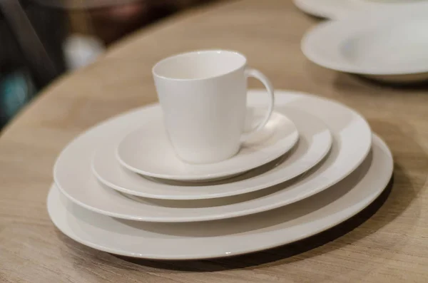 Beautiful and diverse subject. Beautiful stack of plates and glasses in a stylish retro interior in wooden style.