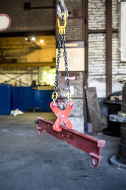 Beautiful and diverse subject. Brutal and rigid chains and metal ropes against the background of the factory and factory premises in the industrial landscape. clipart