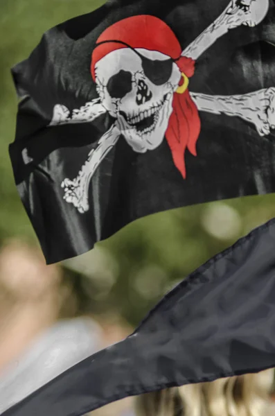 Beautiful pirate flag. Beautiful background and view of the pirate and robber black with bones and skull flag and standard day in summer.